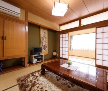 Traditional tatami room with low table, shoji screens and decorative scroll at Yufuin Onsen Oyado Jinnouchi, Oita, Kyushu