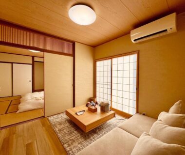 Tatami room with low table, shoji screens and adjoining futon at Yufuin Ryokan Yufumomiji in Ōita, Kyushu