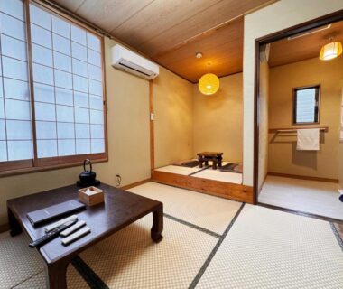 Tatami room with low wooden table, shoji screens and raised seating area at Yufuin Ryokan Yufumomiji, Ōita Kyūshū