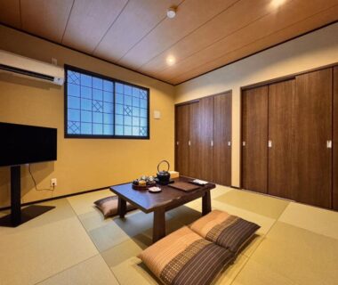 Tatami room with low table, floor cushions, shoji window at Yufuin Ryokan Yufumomiji Ōita