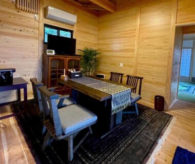 Low wooden dining table and chairs with tatami room visible at Yufuin-Sanso Waremokou, Ōita, Kyūshū