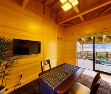 Wood-paneled room with low table and balcony wooden bath at Yufuin-Sanso Waremokou, Ōita, Kyūshū