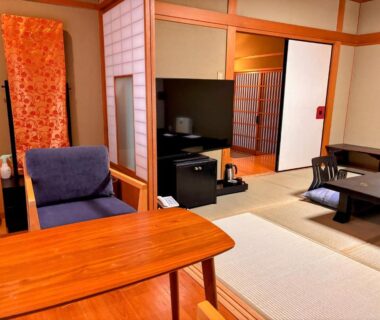 Tatami room with low tables and shoji screens at Yufuin Santoukan in Ōita, Kyūshū