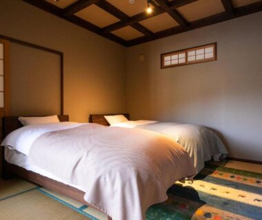 Tatami room with twin beds and shoji screens at Yufuin Tsubaki, Ōita, Kyūshū