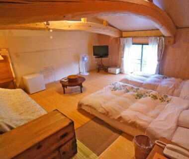 Futon bedding on wooden floor, low table, exposed beams at Yufunoyado Kifu, Ōita, Kyūshū