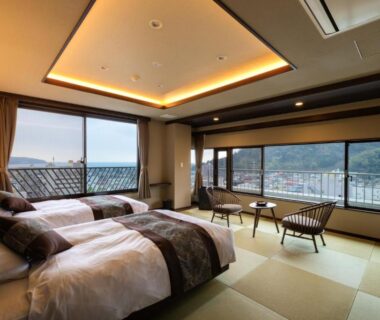 Tatami floor twin room with beds and large windows overlooking the town at Yugawara-Onsen Hotel Shiroyama Kanagawa