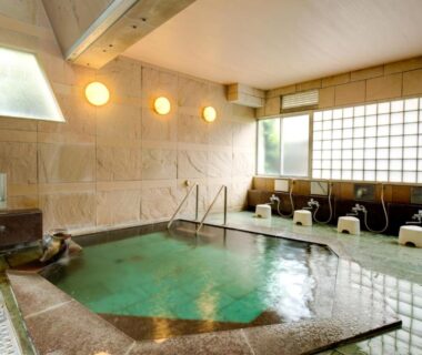 Indoor communal onsen bath with washing stations at Yugawara-Onsen Manyoso, Kanagawa, Japan