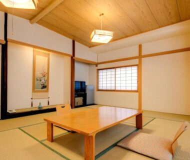Traditional tatami room with low wooden table, zabuton cushions, shoji screen and tokonoma at Yugawara-Onsen Manyoso, Kanagawa