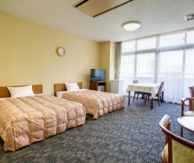 Three single beds, seating area, TV and large window at Yugawara Onsen Mizuno-kaori, Kanagawa