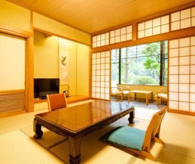 Tatami room with low table, zabuton cushions, shoji screens and garden view at Yugawara-Onsen SUGINA Kanagawa