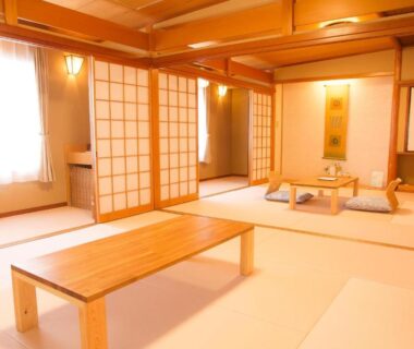 Spacious tatami room with low wooden table, shoji screens and alcove at Yugawara Retreat Goen no Mori, Kanagawa