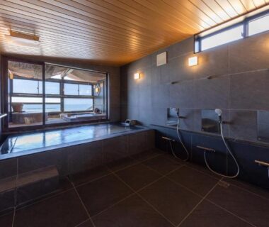 Indoor tiled soaking tub and washing stations with stools at YuhigauraOnsen Umi no Hana Kyoto