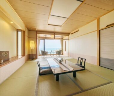 Tatami room with low table, zabuton cushions and sea view at Yuhigauraonsen ShizukaHanaogi, Kyoto