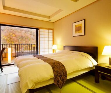 Tatami room featuring twin beds, shoji screens and balcony view at Yukimurasaki, Chūbu Gifu Japan