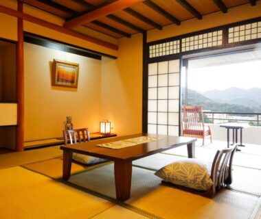 Traditional tatami room with low table, zabuton cushions, balcony chairs and mountain view Yumenoi Hyōgo Kansai