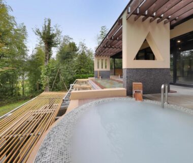 Outdoor onsen bath on wooden terrace overlooking bamboo grove at Yumenoian Yuyake Koyake, Hyōgo