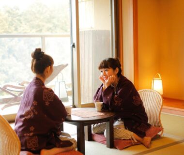 Two guests in yukata seated at low table in tatami room at Yumenoian Yuyake Koyake, Hyōgo