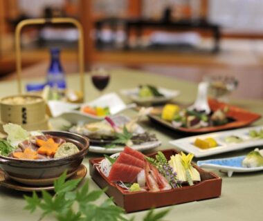 Assorted sashimi and small plates on a low table in a tatami dining room at Yumoto Itaya