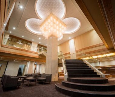 Spacious ryokan lobby with sweeping circular staircase, chandelier and lounge seating at Yumoto Kissho in Miyagi, Tōhoku