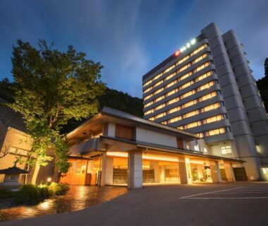 Lit traditional entrance with modern high rise wing at Yumoto Kissho, Miyagi, Tōhoku, Japan