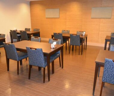 Spacious dining room with wooden floors, tables and upholstered chairs at Yumoto Noboribetsu, Hokkaidō