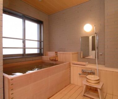 Wooden soaking tub with stool and shower area, Yunohama Hotel, Hokkaidō