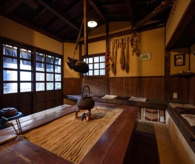 Traditional irori hearth with hanging kettle and wooden interior at Yunohira Kamiyanagiya, Ōita, Kyūshū
