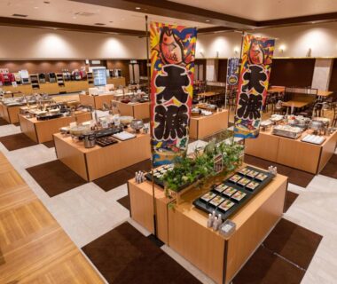 Buffet dining hall with bento stations and banners at Yunokawa Kanko Hotel Shoen, Hokkaidō, Japan
