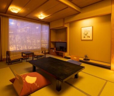 Traditional tatami room with low table, floor cushions, shoji screen window and tokonoma at Yunokuni Tensyo in Ishikawa