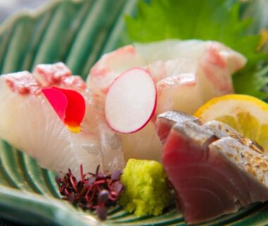 Assorted sashimi with wasabi, lemon and radish garnish at Yunosato Hayama in Ōita, Kyushu