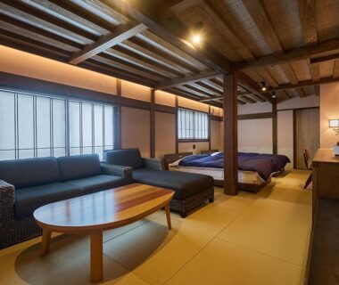 Spacious tatami room with sofa and low beds at Yunoyado Irifune, Kumamoto, Kyūshū