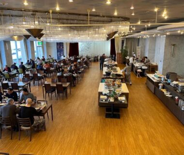 Spacious dining hall with wooden floor and buffet counters at Yura Onsen Yaotome, Yamagata, Tōhoku, Japan