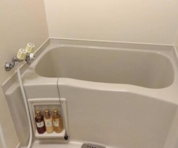 Small soaking tub with handheld shower and toiletries in Yura Onsen Yaotome bathroom, Yamagata