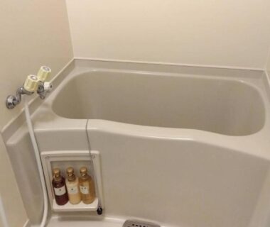 Small soaking tub with handheld shower and toiletries in Yura Onsen Yaotome bathroom, Yamagata