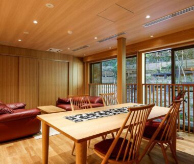 Wooden lounge with table and sofas at Yuraku Kinosaki Spa and Gardens, Hyōgo