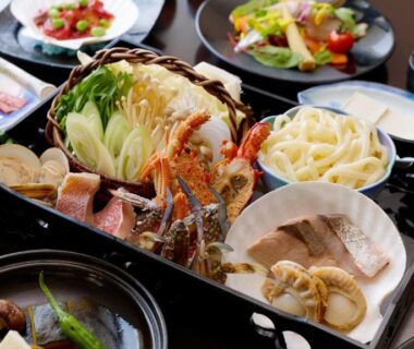 Assorted seafood and vegetables on lacquer trays, multi-course ryokan meal at Yururi Nishiizu Shizuoka