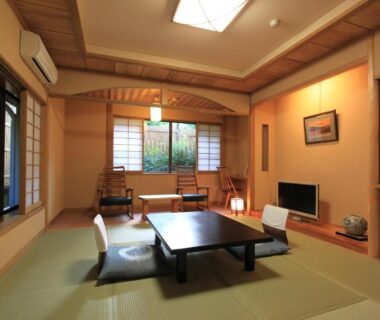 Japanese tatami room with low table, floor chairs, shoji screens and garden view at Yusakaso in Kanagawa