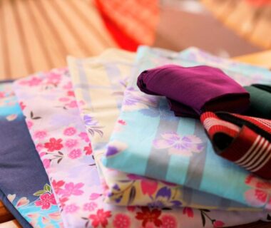 Assorted floral yukata and obi on woven mat at Yutorelo Beppu, Ōita, Kyūshū