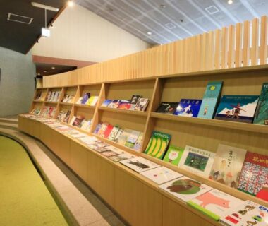 Cozy lounge with wooden bookshelves and seating at Yutorelo Nasushiobara, Tochigi