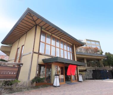 Entrance with red noren and wooden facade at Yutorelo Toyako in Hokkaido