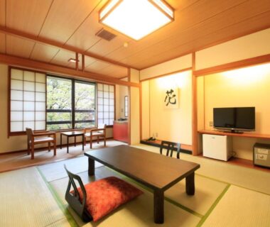 Tatami room with low table, floor cushions, shoji screens and window seating at Yutorelo-an, Kanagawa