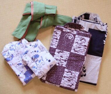 Folded yukata robes and obi on tatami floor