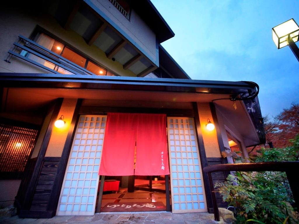 Ryokan entrance with red noren Yutorelo-an Kanagawa Dusk entrance with red noren and shoji screens at Yutorelo-an in Kanagawa