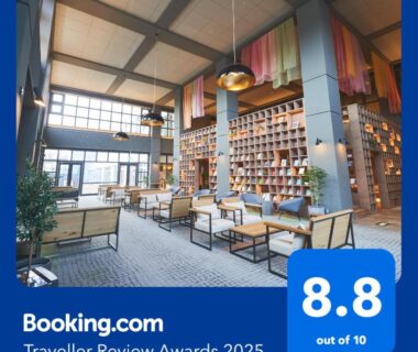 Atrium lounge with high ceiling, bookshelves and seating at Yuuyu No Sato Yusa, Tōhoku Yamagata