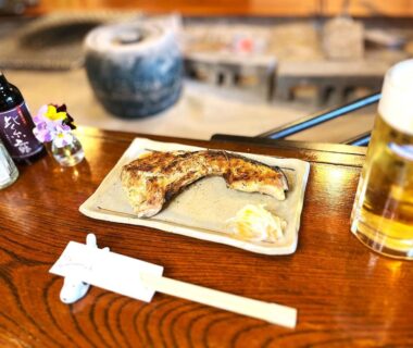 Grilled fish on ceramic plate with beer and chopsticks at Yuuzuru ryokan, Shizuoka, Chūbu Japan