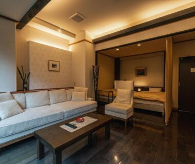 Sofa and low table in guest room at Yuyado DAIICHI Hokkaidō