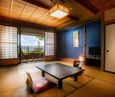 Traditional tatami room with low table, floor cushions and shoji doors opening to balcony at Yuyaruru Saisai, Ishikawa