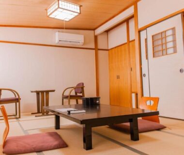Traditional tatami room with low table, zabuton cushions and zaisu chairs at Yuzennoyado Toukai in Saga