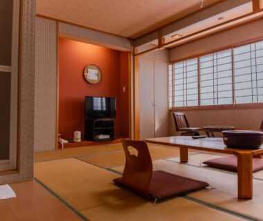 Tatami room with low table, zabuton cushions and shoji screens at Yuzennoyado Toukai in Saga, Kyushu