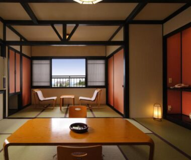 Tatami room with low table and window seating at Zao Onsen Omiya Ryokan in Yamagata